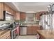 Functional kitchen features stainless steel appliances, tile backsplash, and lots of cabinet space at 41838 W Anne Ln, Maricopa, AZ 85138