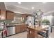 Well-equipped kitchen featuring stainless steel appliances, kitchen island, and pendant lighting at 41838 W Anne Ln, Maricopa, AZ 85138