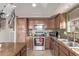 Lovely kitchen with granite countertops, stainless steel appliances, and wooden cabinetry at 41838 W Anne Ln, Maricopa, AZ 85138