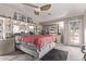 Bright main bedroom with a ceiling fan, carpet floors, and a glass door to the outside at 41838 W Anne Ln, Maricopa, AZ 85138