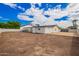 Backyard view featuring a covered patio, privacy wall, and ample space ready for landscaping and outdoor enjoyment at 4402 E Mitchell Dr, Phoenix, AZ 85018