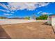 Expansive backyard featuring a large, flat lot surrounded by a privacy wall and a clear blue sky at 4402 E Mitchell Dr, Phoenix, AZ 85018