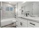 Bright bathroom featuring white cabinetry, granite counters, tile flooring, and tiled shower with a window at 4402 E Mitchell Dr, Phoenix, AZ 85018