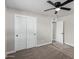 Cozy bedroom with carpet, a ceiling fan, and closet with classic white paneled doors in a neutral color palette at 4402 E Mitchell Dr, Phoenix, AZ 85018