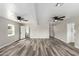 Spacious living room with modern gray and brown vinyl flooring and ceiling fans at 4402 E Mitchell Dr, Phoenix, AZ 85018