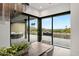 Dining area featuring walls of glass with outdoor living area and mountain views at 5301 E Paradise Canyon Rd, Paradise Valley, AZ 85253