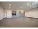 Spacious garage featuring custom gray cabinets for ample storage and organization with epoxy floors at 5301 E Paradise Canyon Rd, Paradise Valley, AZ 85253