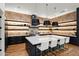 Spacious kitchen with large center island, modern pendant lighting, and custom shelving at 5301 E Paradise Canyon Rd, Paradise Valley, AZ 85253