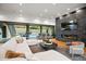 Open-concept living room with modern fireplace, stone accent wall and access to backyard swimming pool at 5301 E Paradise Canyon Rd, Paradise Valley, AZ 85253