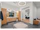 Bright bathroom featuring natural wood cabinets, dual vanities, and stylish lighting, with view to bedroom at 5301 E Paradise Canyon Rd, Paradise Valley, AZ 85253