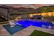 Stunning pool with integrated lighting, outdoor fireplace and cozy patio seating at 5301 E Paradise Canyon Rd, Paradise Valley, AZ 85253