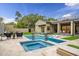 Beautiful backyard pool area with modern lounge chairs, a spa, and well-manicured landscaping at 5301 E Paradise Canyon Rd, Paradise Valley, AZ 85253