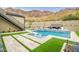 Backyard pool and patio with unique decorative accents and a mountain backdrop, ideal for relaxation at 5301 E Paradise Canyon Rd, Paradise Valley, AZ 85253