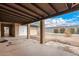 Covered patio area in the backyard featuring desert landscaping and block fence at 5401 S Siesta Ln, Tempe, AZ 85283