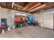 Unfinished basement with exposed ceiling, storage shelves, and work space at 5401 S Siesta Ln, Tempe, AZ 85283