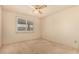 Neutral bedroom with large window providing ample natural light and a ceiling fan at 5401 S Siesta Ln, Tempe, AZ 85283