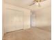 Bedroom featuring neutral carpet, a ceiling fan, and a large closet with sliding doors at 5401 S Siesta Ln, Tempe, AZ 85283