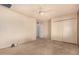 Neutral bedroom with plush carpet, closet with sliding doors, and ceiling fan at 5401 S Siesta Ln, Tempe, AZ 85283