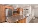 Bright kitchen with stainless steel appliances, wooden cabinetry, and a large center island for ample counter space at 5401 S Siesta Ln, Tempe, AZ 85283