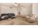 Comfortable living room featuring neutral carpet, a ceiling fan, and an inviting, open floor plan at 5401 S Siesta Ln, Tempe, AZ 85283