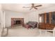 Cozy living room with a brick fireplace, comfortable seating, and a classic built-in cabinet for storage and display at 5401 S Siesta Ln, Tempe, AZ 85283