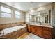 Luxurious bathroom features a soaking tub, granite vanity, and elegant tile accents at 567 W 6Th St, Tempe, AZ 85281