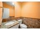 Stylish powder room features granite countertop, tiled wainscoting, and neutral paint at 567 W 6Th St, Tempe, AZ 85281