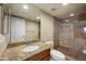 Modern bathroom with granite countertop, framed mirror, and walk-in glass shower at 567 W 6Th St, Tempe, AZ 85281