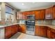 Well-equipped kitchen with granite counters, stainless steel appliances, and wood cabinetry at 567 W 6Th St, Tempe, AZ 85281