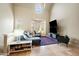 Sunlit living room with a plush sofa, modern TV setup, and views from large bay windows at 567 W 6Th St, Tempe, AZ 85281