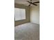 Cozy bedroom featuring a ceiling fan and a large window offering ample natural light at 6780 W Yearling Rd, Peoria, AZ 85383