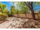 Paver backyard shaded by mature trees, offering a serene and private outdoor space at 73 E Caroline Ln, Tempe, AZ 85284