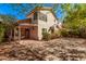 Expansive paver backyard with mature trees, charming string lights, and a cozy covered patio at 73 E Caroline Ln, Tempe, AZ 85284