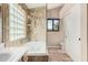 Bathroom featuring a whirlpool tub surrounded by glass block and decorative tile at 73 E Caroline Ln, Tempe, AZ 85284