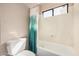 Bright bathroom showcasing a shower and tub combo with a stylish curtain and natural light from the window at 73 E Caroline Ln, Tempe, AZ 85284