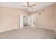 Neutral bedroom includes a carpet, high ceilings, and access to ensuite bath through double doors at 73 E Caroline Ln, Tempe, AZ 85284