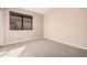 Bedroom featuring a large window letting in natural light, neutral walls and carpet flooring at 73 E Caroline Ln, Tempe, AZ 85284