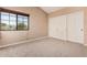 Bedroom featuring a window with a view, neutral walls, carpet, and a closet with panel doors at 73 E Caroline Ln, Tempe, AZ 85284