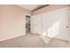 Bedroom with neutral walls and carpet flooring, a closet and an open doorway at 73 E Caroline Ln, Tempe, AZ 85284