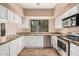 This kitchen features stainless steel appliances, granite countertops, and updated lighting at 73 E Caroline Ln, Tempe, AZ 85284