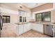 Well-lit kitchen showcases stainless steel appliances, granite countertops, and white cabinets at 73 E Caroline Ln, Tempe, AZ 85284