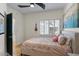 Light filled bedroom featuring neutral wall color, shutters, modern decor and ensuite bath at 7420 E Northland Dr # B101, Scottsdale, AZ 85251