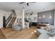 Open-concept living room showcasing hardwood floors, a staircase, and an adjacent dining area and kitchen at 7420 E Northland Dr # B101, Scottsdale, AZ 85251