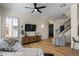 Bright living room boasting hardwood floors, a ceiling fan, and natural light through shuttered windows at 7420 E Northland Dr # B101, Scottsdale, AZ 85251