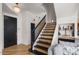 Interior view of an open staircase featuring wood treads, black risers and bannister, and open concept living at 7420 E Northland Dr # B101, Scottsdale, AZ 85251