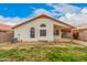 The backyard featuring partial grass, minimal landscaping, and a covered patio at 7929 W Wescott Dr, Glendale, AZ 85308