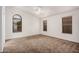 Bedroom with carpet flooring, a ceiling fan, and multiple windows at 7929 W Wescott Dr, Glendale, AZ 85308