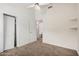 Bedroom featuring a closet, neutral carpet and view into ensuite bathroom at 7929 W Wescott Dr, Glendale, AZ 85308