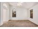 Bedroom with carpet flooring, a ceiling fan, and large windows at 7929 W Wescott Dr, Glendale, AZ 85308