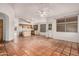 Open-concept kitchen with a breakfast bar, white appliances, wood cabinets, and access to living area at 7929 W Wescott Dr, Glendale, AZ 85308